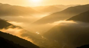 An AI-generated image of rolling hills and a river in the golden hour