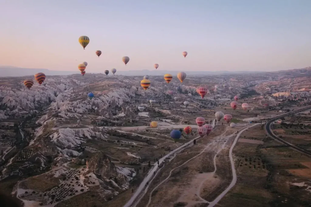 An image of hot air balloons over mountains