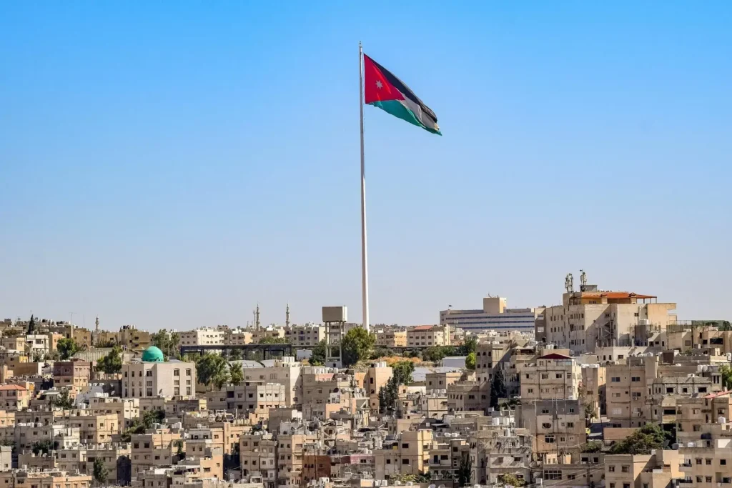 The flag of Jordan flying over Amman